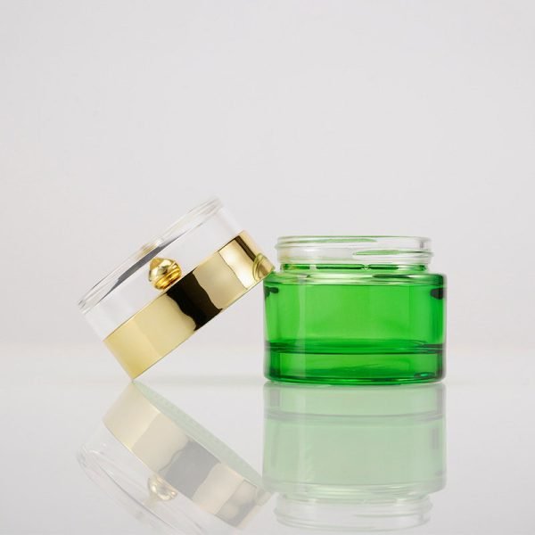 green glass cream jar with clear cap