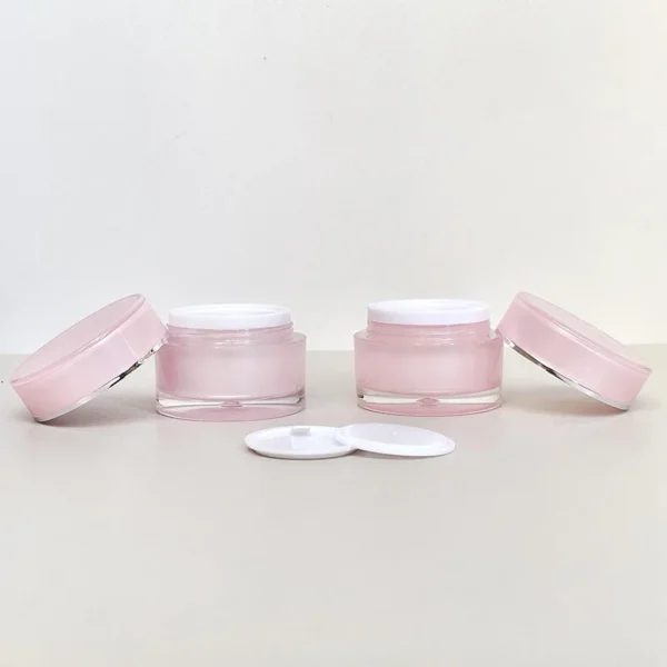 pink cosmetic facial cream containers