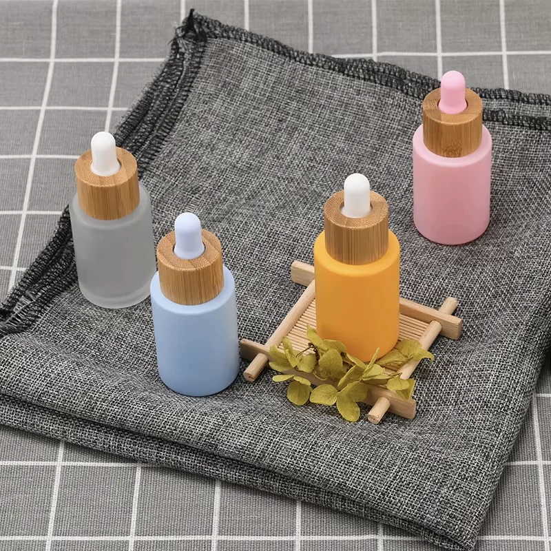 empty essential oil bottles with bamboo dropper lids
