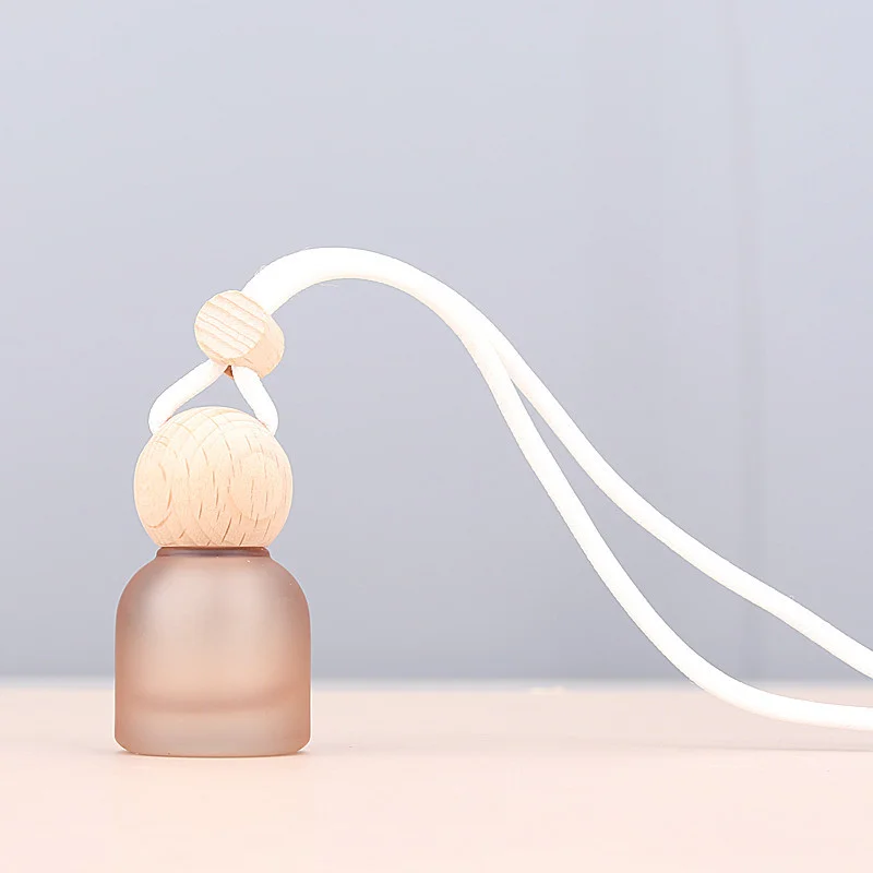 empty car freshener bottle with wood cap