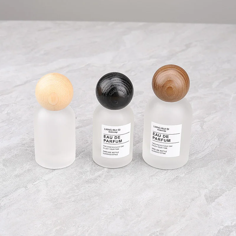 frosted glass spray bottle with wood lid