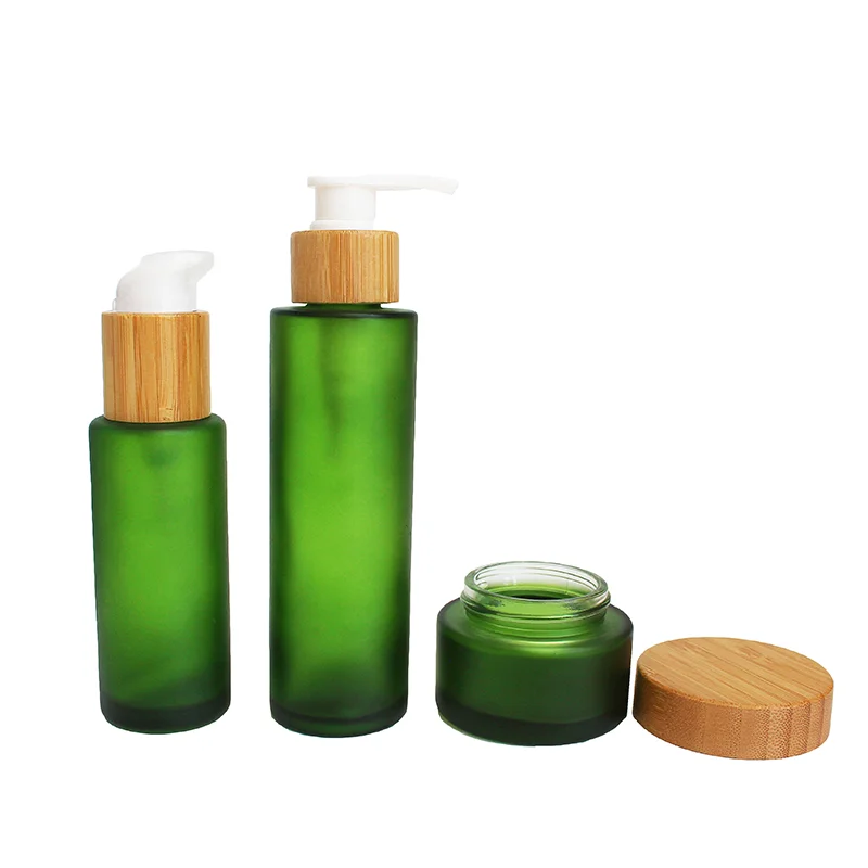 green glass lotion pump bottles and cream jar