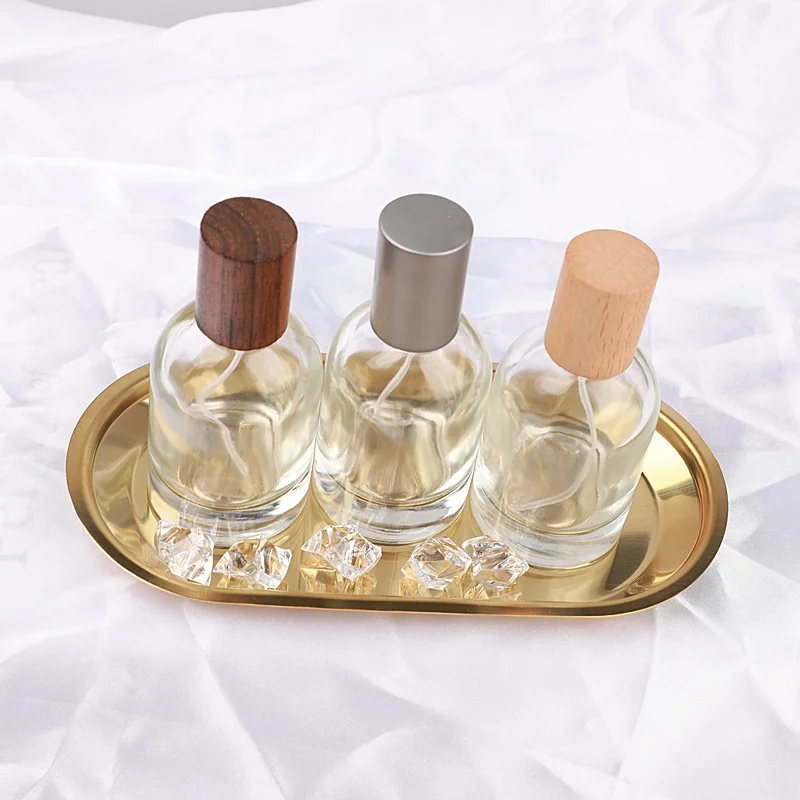 round clear glass perfume bottle with wood cap